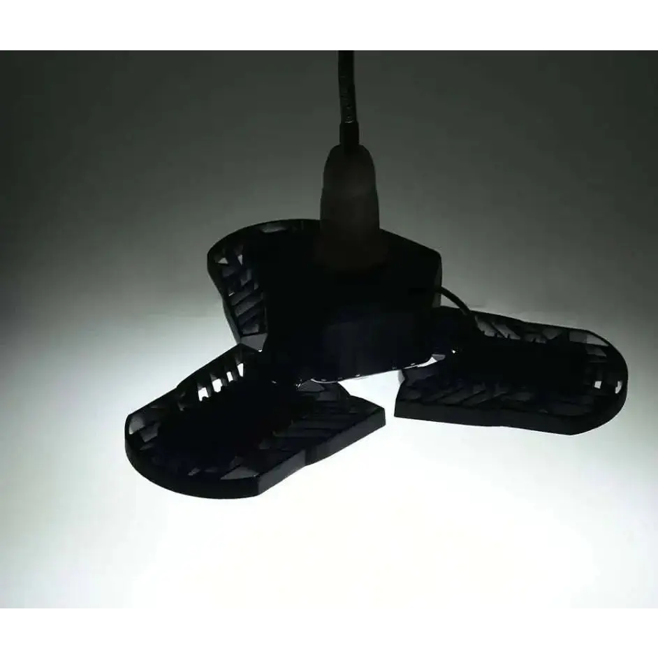 Black plastic three-bladed ceiling fan with central motor housing and visible wiring for deformable lamp garage light adjustable panels