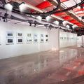 White framed photographs displayed in a gallery wall showcasing the deformable lamp garage light with adjustable panels