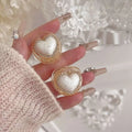 Delicate gold diamond love pearl heart ring with heart-shaped nail art decals featuring white textured center and gold edges
