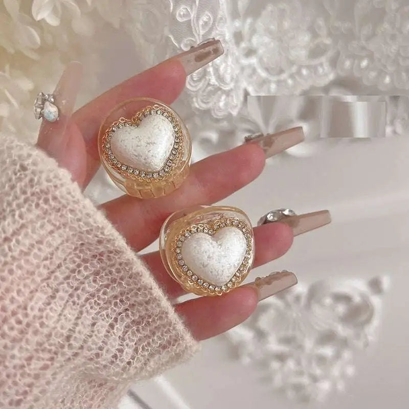 Delicate gold diamond love pearl heart ring with heart-shaped nail art decals featuring white textured center and gold edges
