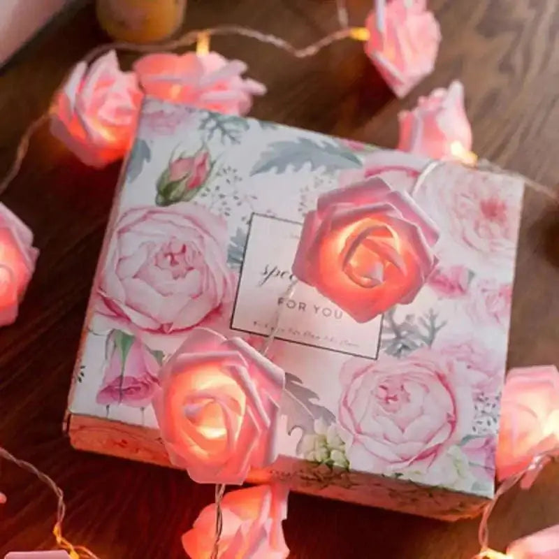 Delightful rose lights featuring pink led roses with warm glowing centers arranged around a floral woven basket gift box