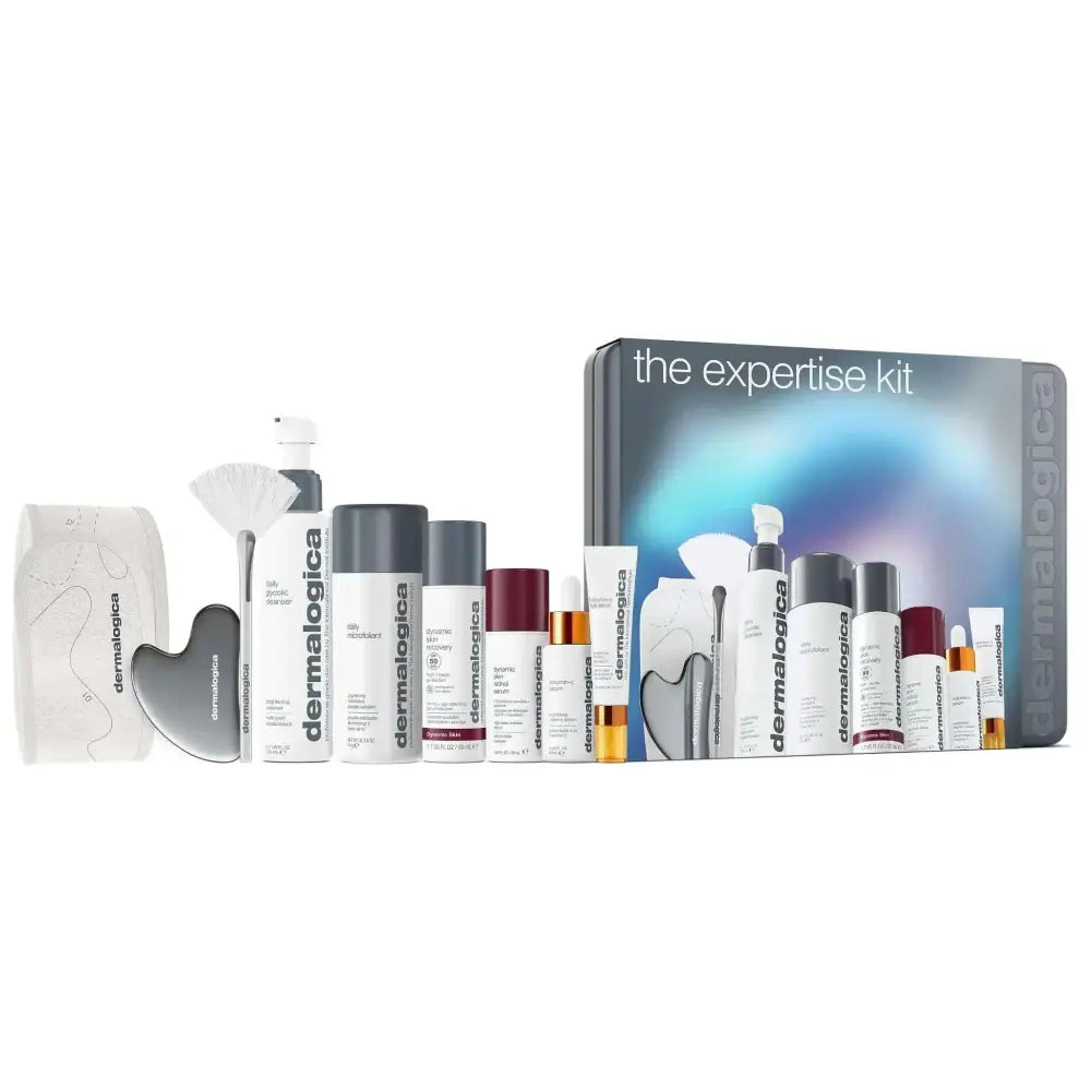 The dermalogica expertise kit holiday gift features a blue and silver box with skincare products and a gua sha tool