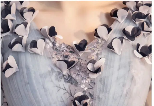 a delicate light blue long skirt with intricate black and white paper-like heart embellishments designed for vocal choral art exam performances