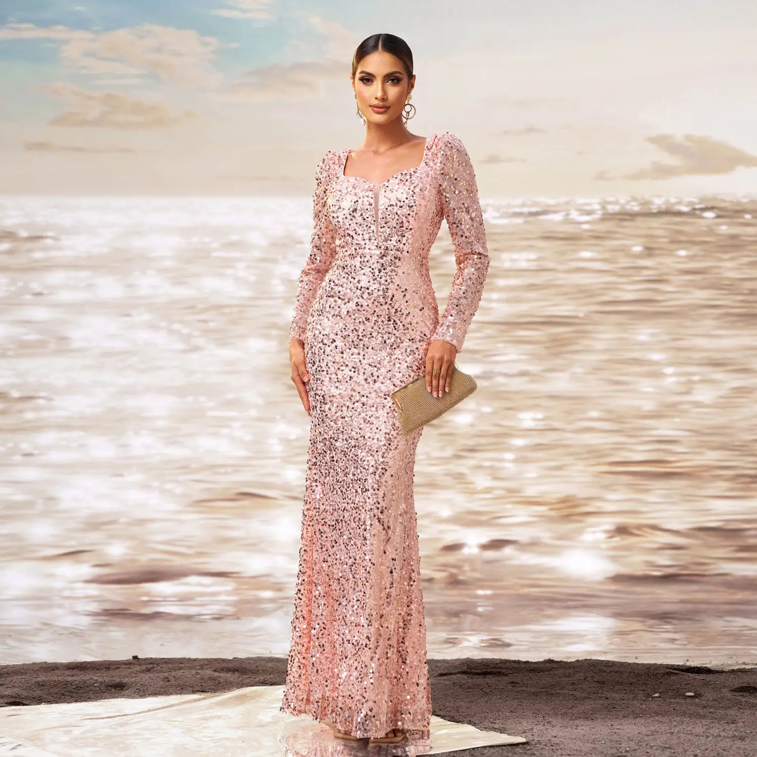 A shimmering pink long sleeve sequined sheath fishtail evening dress with a square neckline.