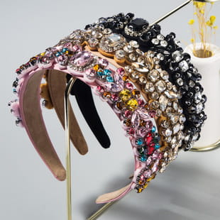 A glamorous baroque colorful headband featuring multi-layered design adorned with sparkling pink gold and black rhinestones.