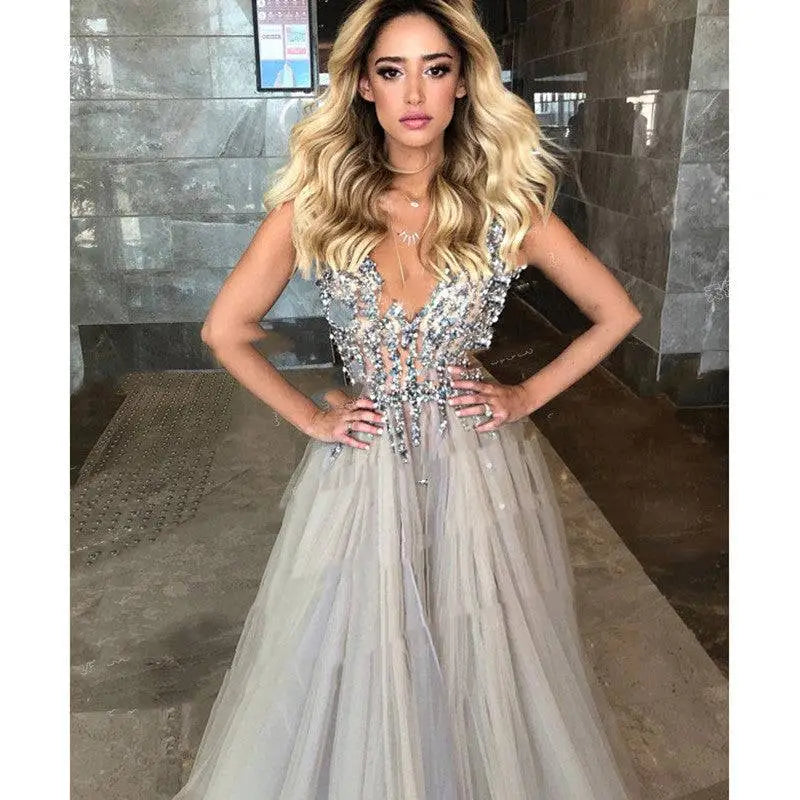Diamond grey banquet beaded evening dress featuring a shimmering silver beaded gown with deep v-neck and flowing tulle skirt