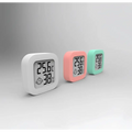 Three digital display temperature and humidity meters in white pink and mint green silicone casings for humidity measurement