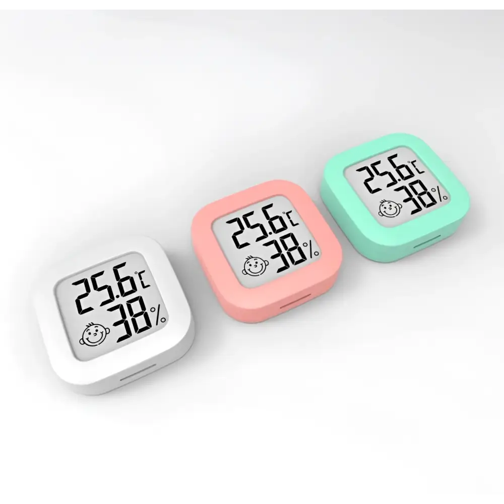 Digital display temperature and humidity meter in pastel colors showing 25.6°c humidity measurement and smiling face icon