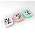 Digital display temperature and humidity meter in pastel colors showing 25.6°c humidity measurement and smiling face icon