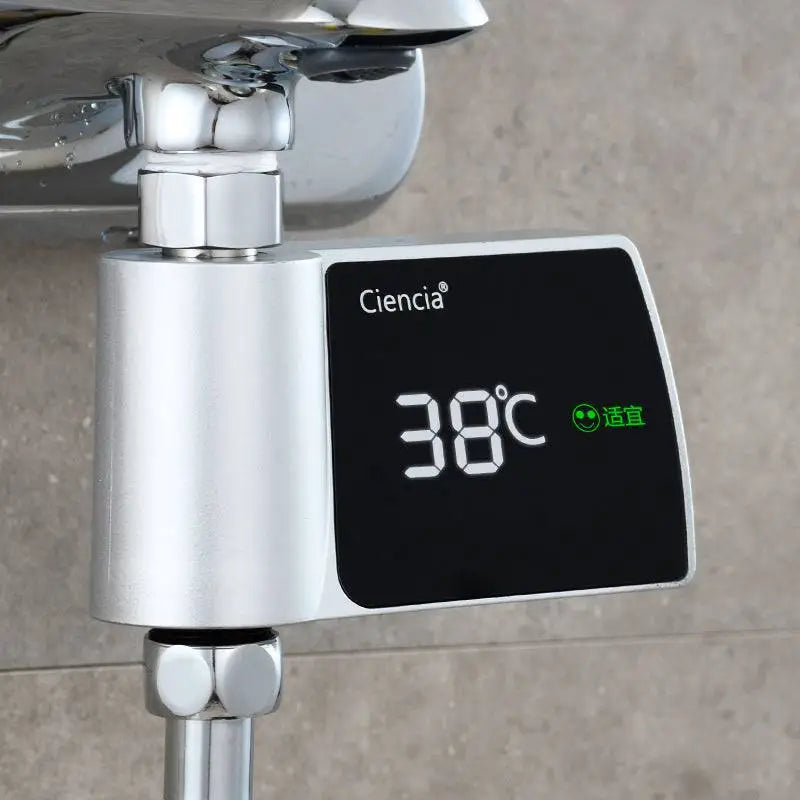 Silver-colored ciencia digital plastic visual shower faucet with black display showing 38°c and green smiley for consumption water monitoring
