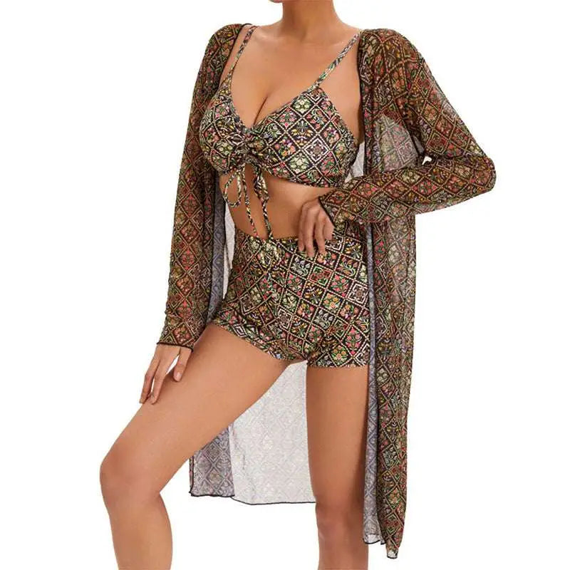 A woman wears a digital printing pleated tie bikini in earthy tones with a matching sheer long-sleeved cover-up
