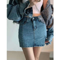Mid-rise black denim skirt with five-pocket design, frayed hem, and side slit in high-waisted distressed denim style