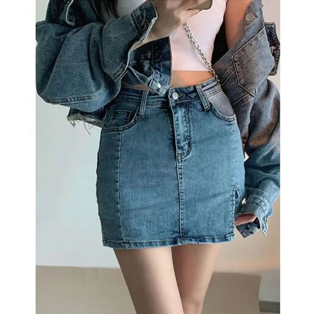 Mid-rise black denim skirt with five-pocket design, frayed hem, and side slit in high-waisted distressed denim style