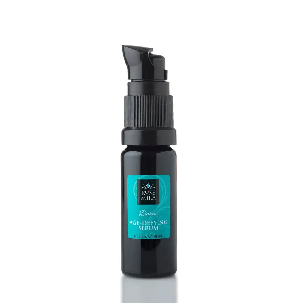Black glass bottle with pump dispenser and teal label displaying divine age-defying serum for skin care