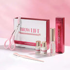 Pink-handled professional brow lamination kit with scissors comb and adhesive bottles in branded lamination eyebrow kit box