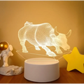 A glowing white 3d illusion led night light shaped like a bull with colorful touch remote and remote control lights