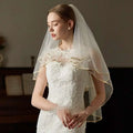 Ivory lace bridal veil with double champagne edge metal hair comb and gold-trimmed flowing design