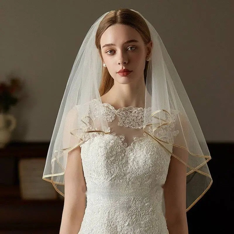 Double champagne edge metal bridal veil featuring delicate ivory lace with gold trim and soft ruffled edges