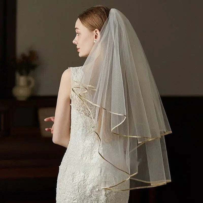 Ivory lace bridal veil with delicate translucent fabric double champagne edge metal comb and elegant ruffled trim