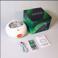 White flying saucer-shaped northern lights projector lamp with ribbed exterior and orange button for effect northern lights