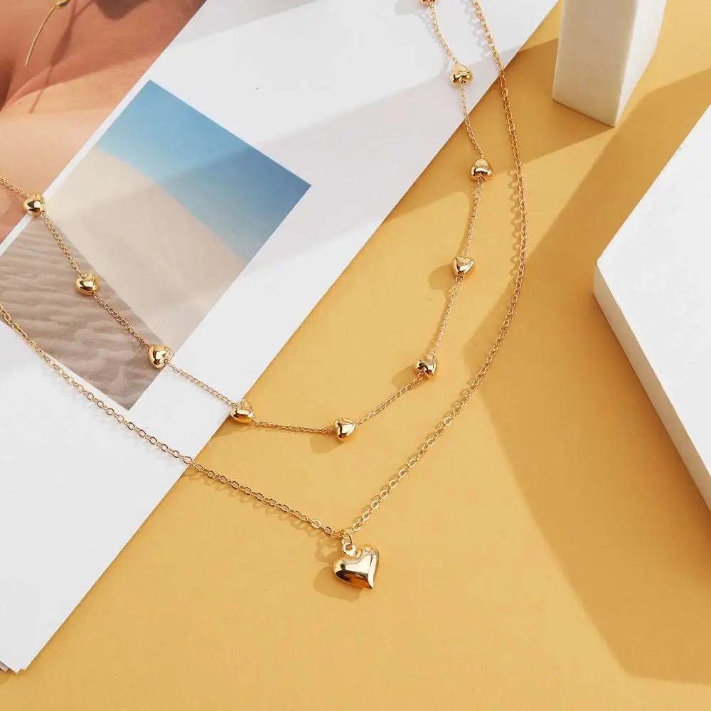 Gold-toned double layer heart pendant fine chain necklace with delicate chains and small heart-shaped charms