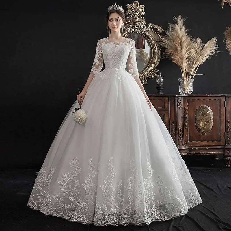 Elegant dream slim sleeve lace ivory wedding gown with three-quarter sleeves and large size voluminous tulle skirt