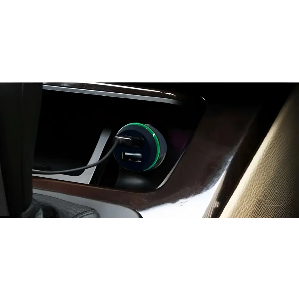 A sleek dual usb car hands free phone music player with a black body and vibrant green circular rim