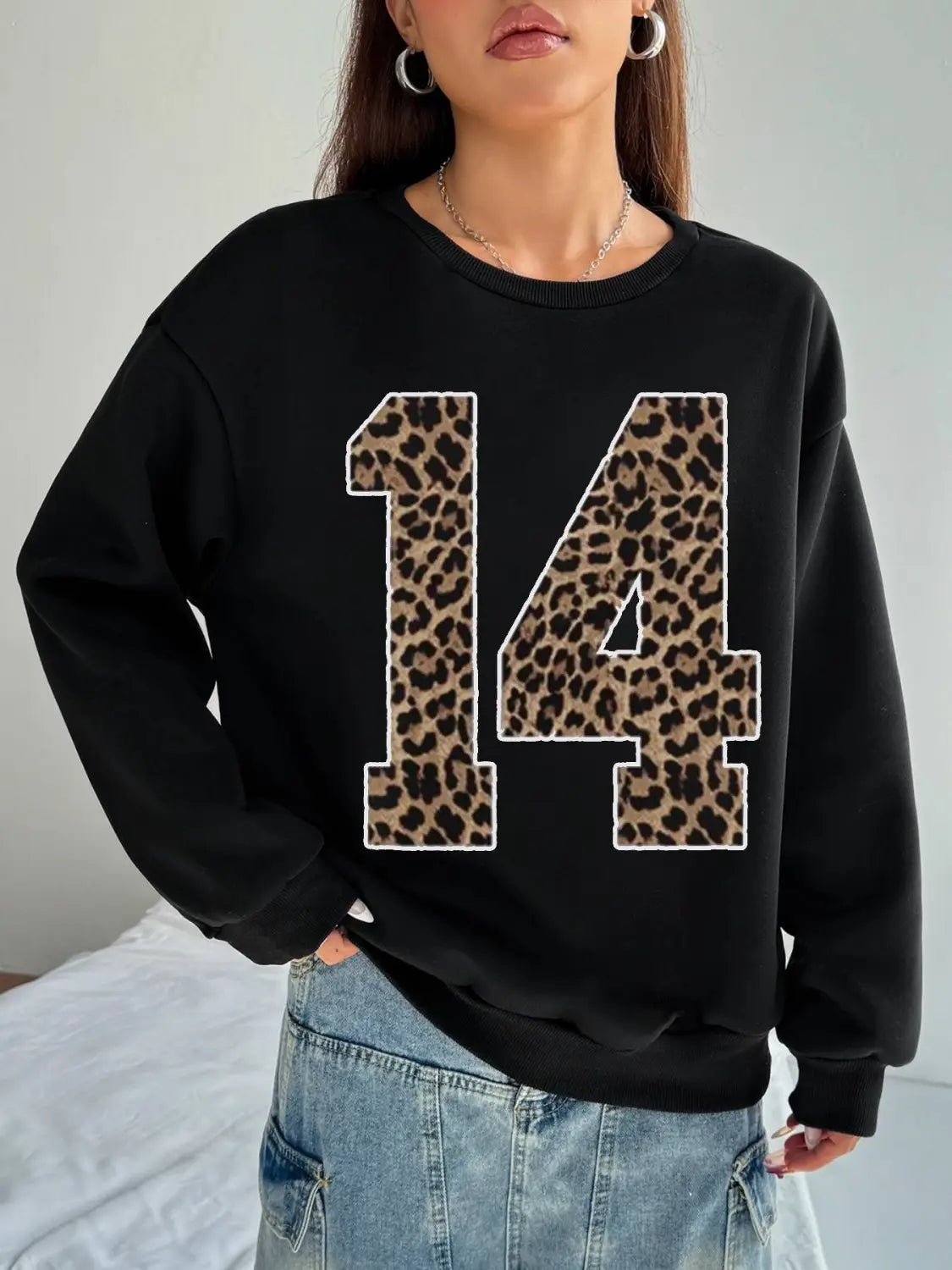 black crew neck sweatshirt featuring a bold leopard print number 14 across the chest