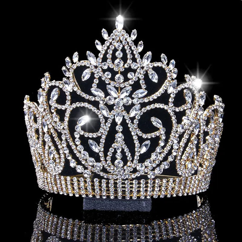 A luxury rhinestone bridal crown featuring a sparkling gold tiara with intricate crystal embellishments and a central diamond accent, designed as an american bridal crown with a starburst accent.