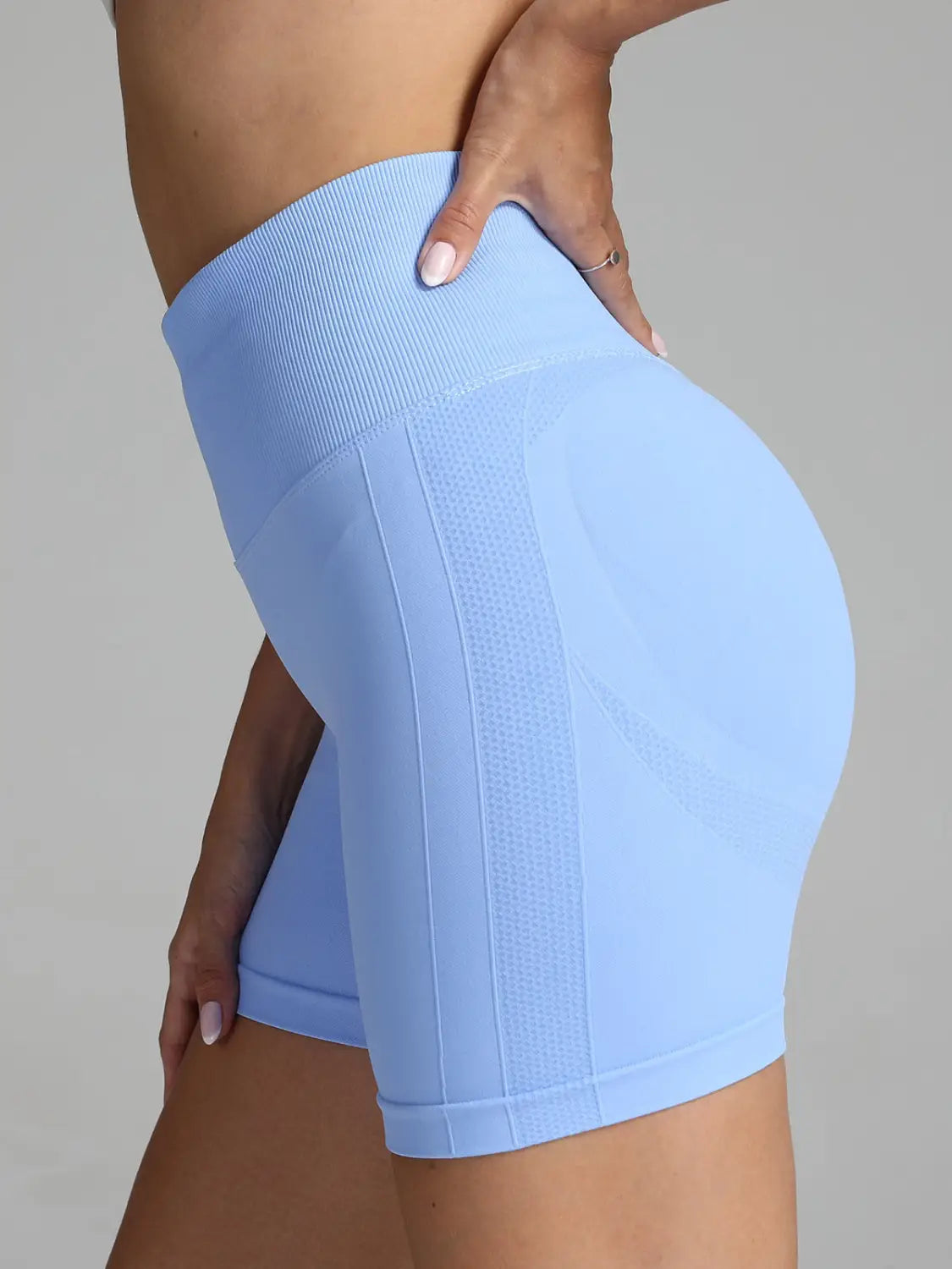 light blue high-waisted seamless yoga shorts women with a ribbed waistband and textured side panels designed for solid color activewear.