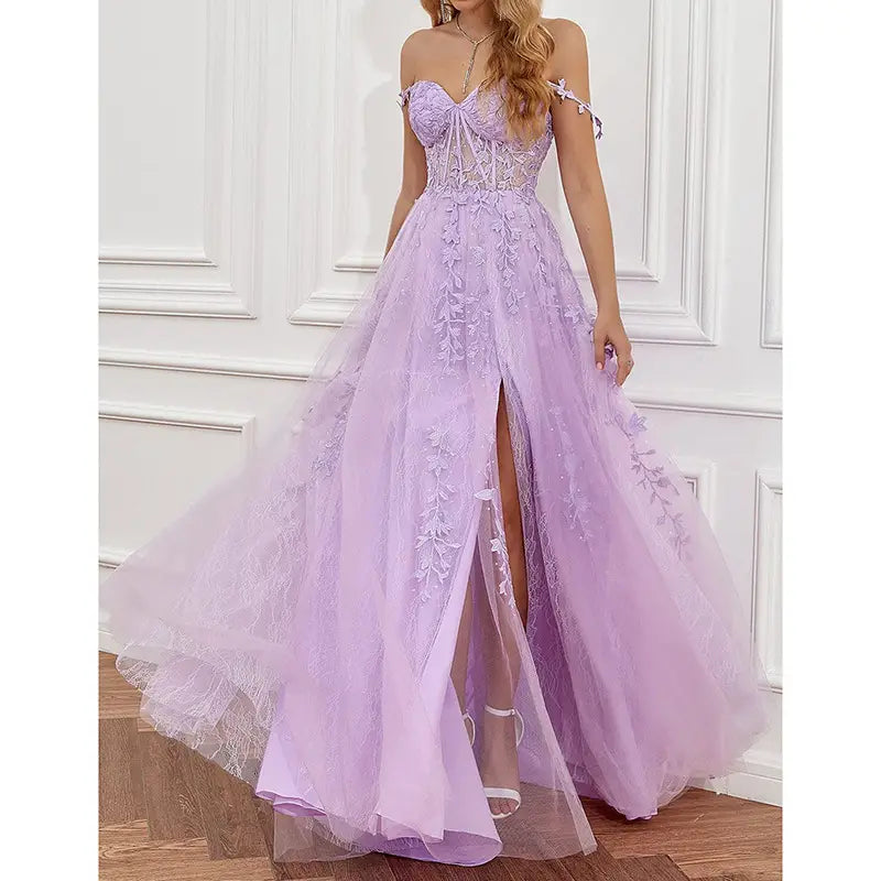 A lavender lace off shoulder prom dress made of tulle with intricate floral lace detailing and a high slit suitable for red carpet runway events.