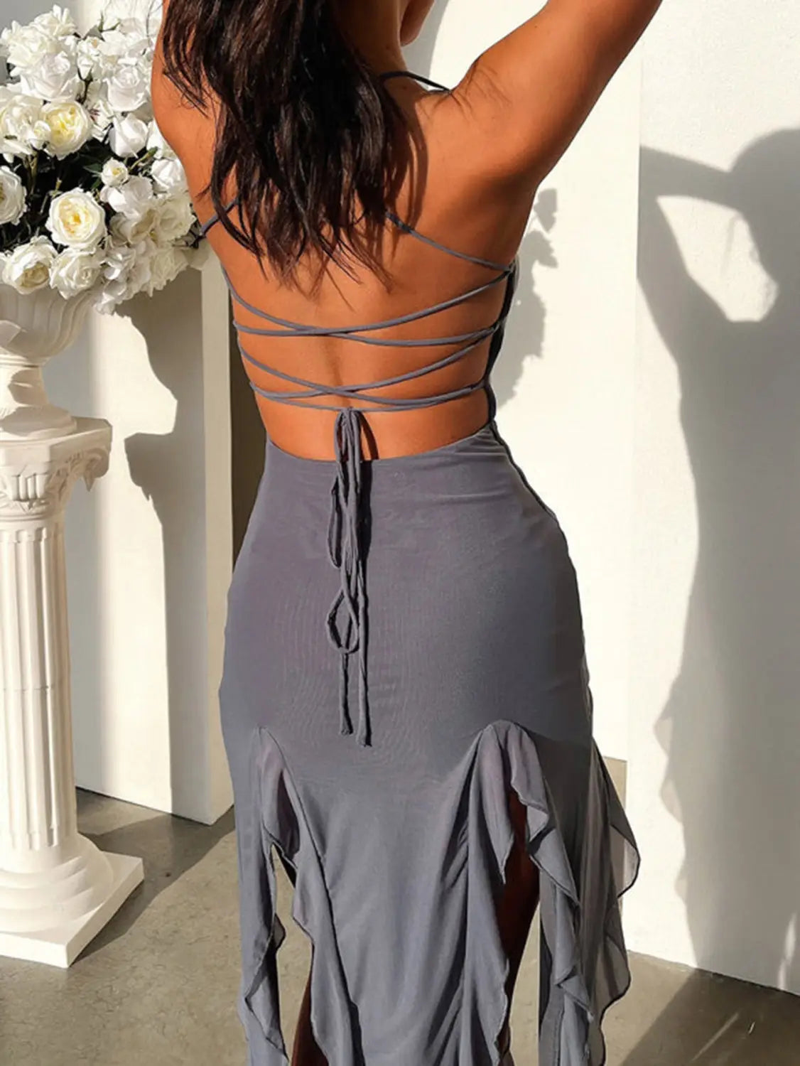 a sleek gray backless dress featuring a crisscross lace-up design and flowing ruffled hem, exemplifying a sexy suspender tight slim skirt style