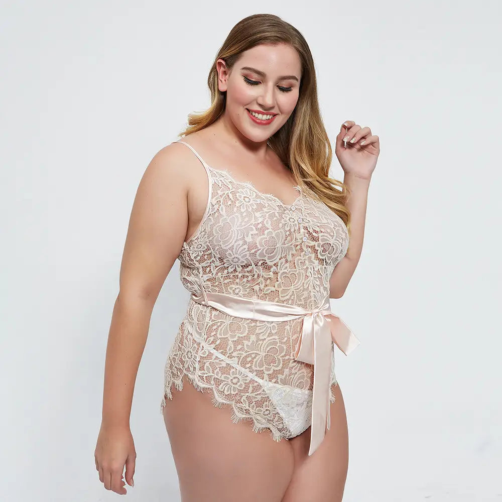 Delicate off-white oversized lace lace bodysuit featuring a satin ribbon belt tied at the waist.