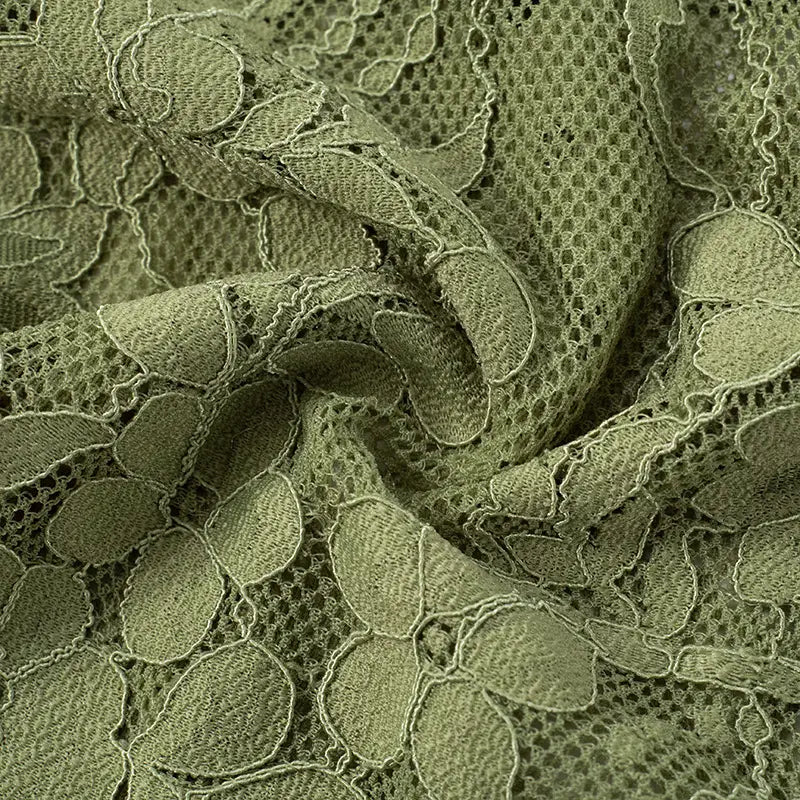 olive green lace fabric with intricate floral patterns and delicate textured embroidery featured on a sage green lace backless tube with sling stitching ruffle and stitching ruffle hip design.