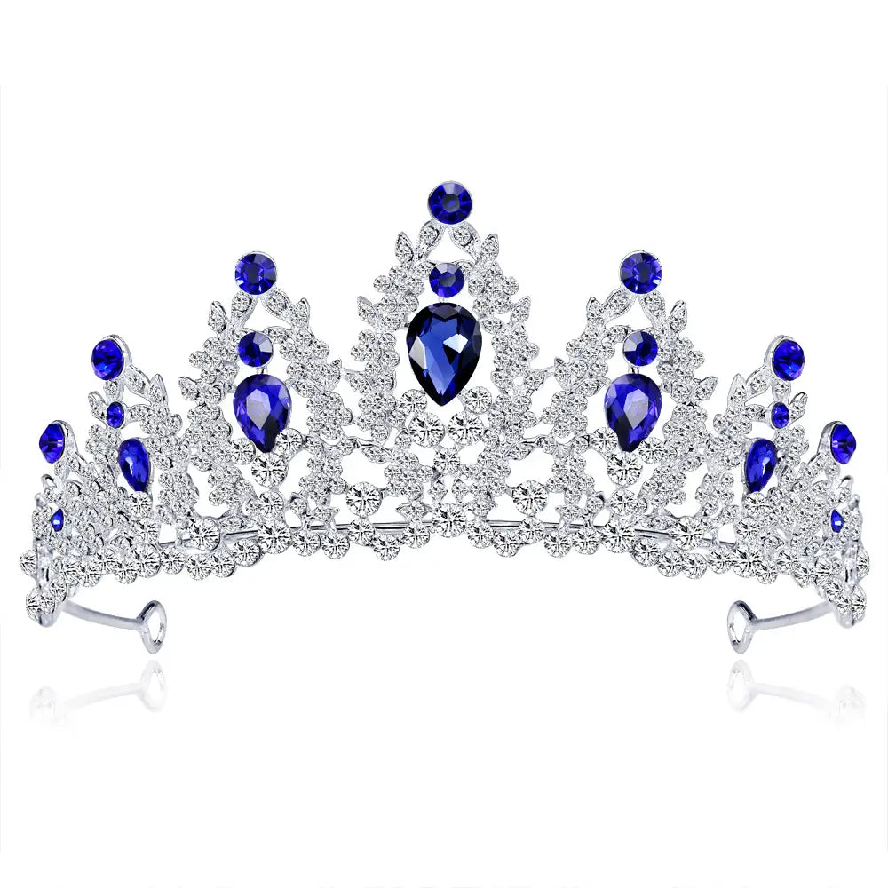 A sparkling silver bridal crown european adorned with deep blue teardrop and round crystals featuring an intricate leaf-like design.