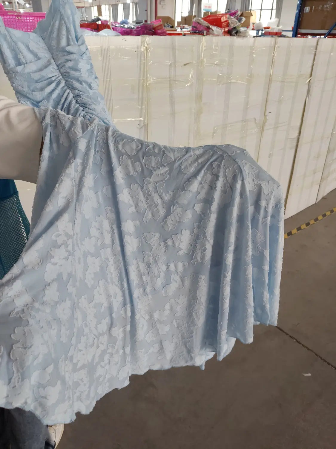 A light blue lace sexy evening dress with a ruched bodice and floral pattern perfect for backless sexy evening occasions.