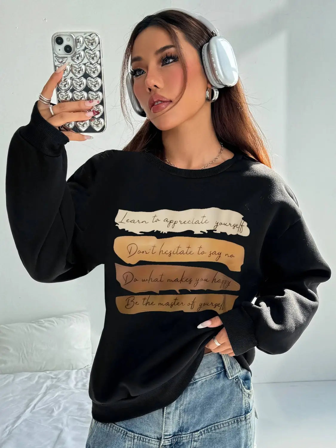 Black long sleeve sweatshirt with motivational quotes printed in beige and gold on the front for daily wear in a solid colour design