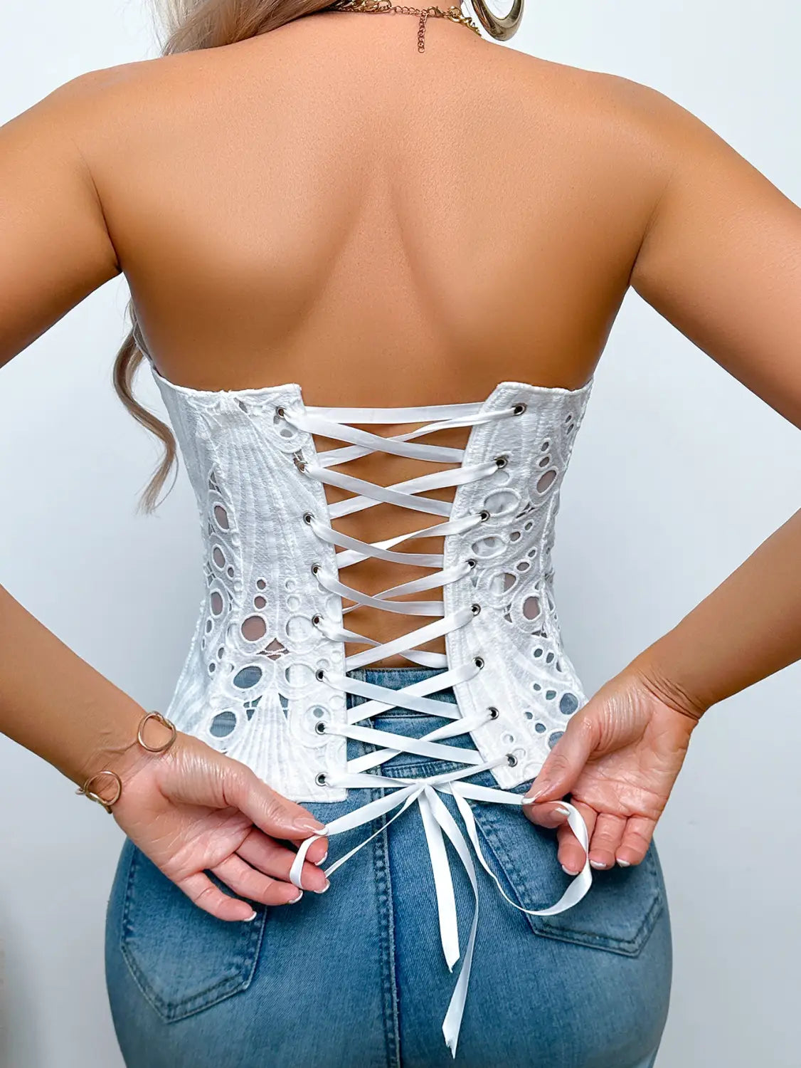 White lace party club corset clothing featuring intricate hollow out patterns and matching lacing ideal for streetwear party club looks.
