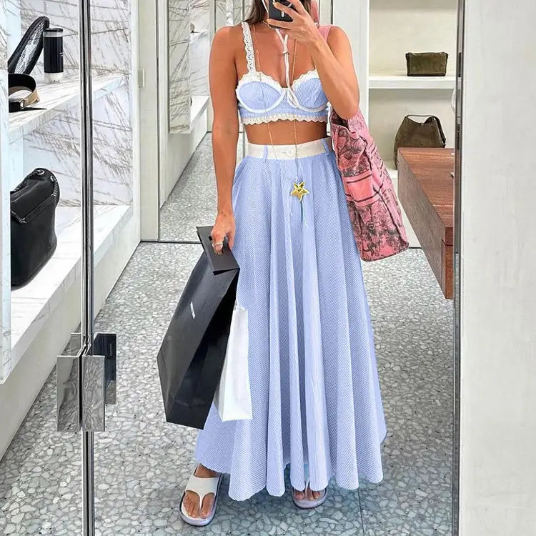 light blue textured midi skirt with white waistband and small gold star pin paired with lace splicing sling vest in splicing sling vest high style.