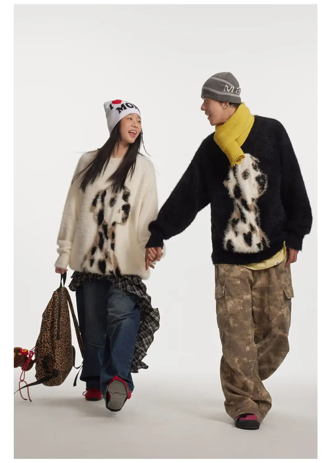Cream-colored mink cashmere knitted sweater featuring a black and white dalmatian puppy jacquard mink pattern.