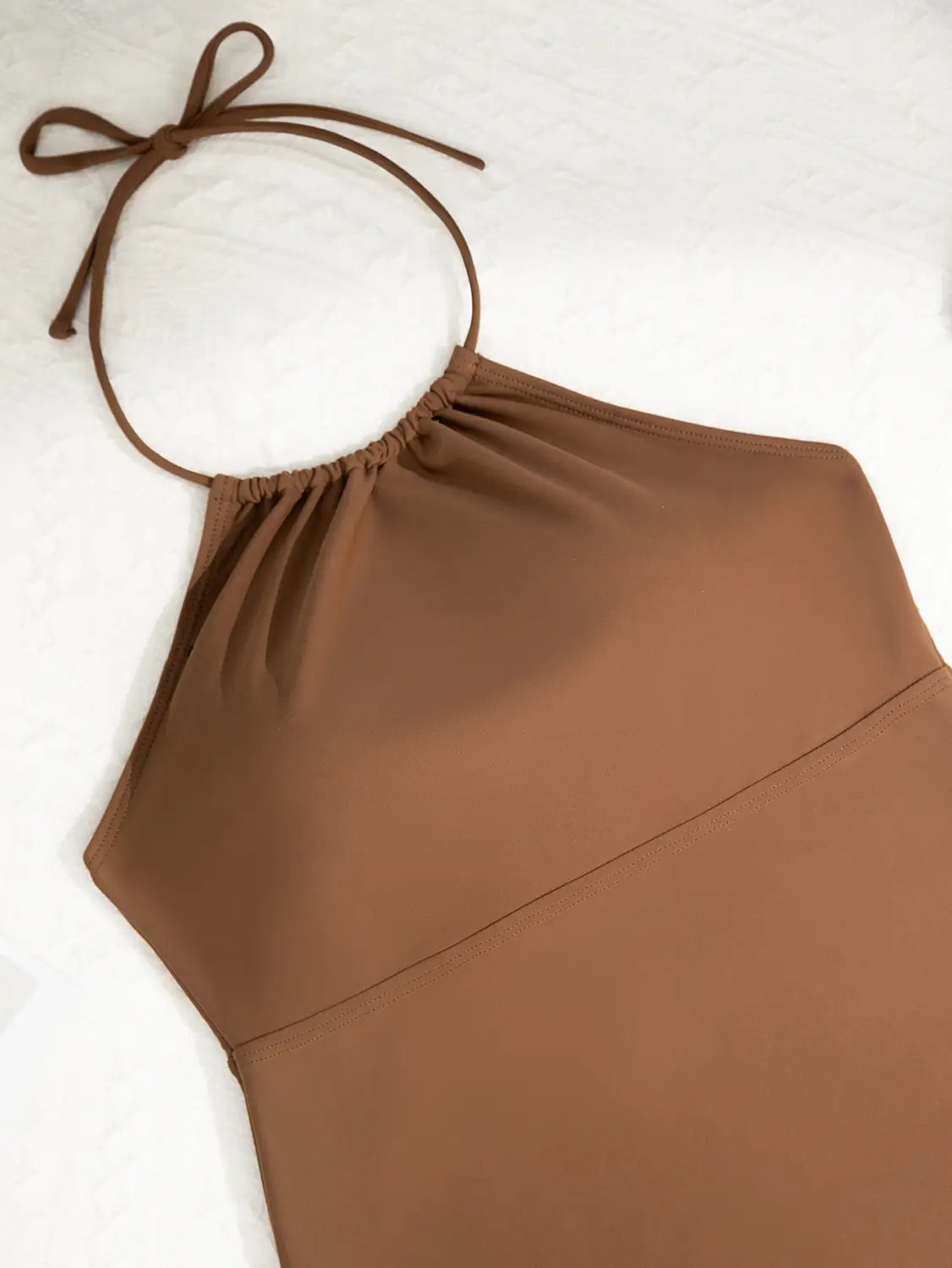 A sleek solid brown halterneck dress with a gathered neckline and adjustable tie straps suitable as a stylish alternative to a split swimsuit or printed halter bikini.