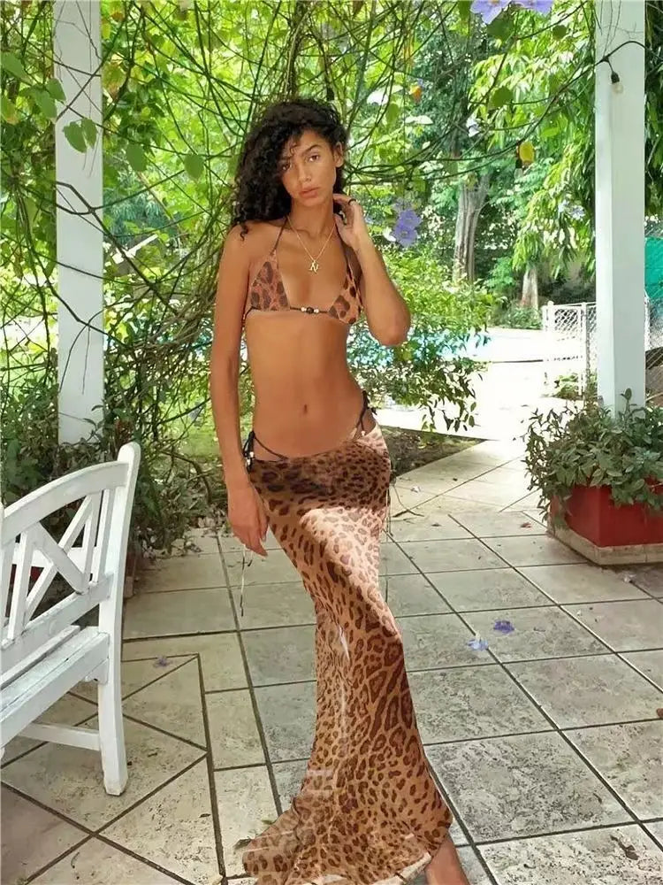 a flowing leopard-print maxi skirt with high-waisted design and side slits styled as a printed bikini strappy casual skirt