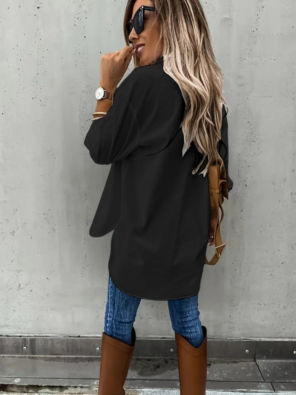 black long sleeve oversized top with a loose long sleeve design and relaxed fit featuring a curved hemline and lapel detailing