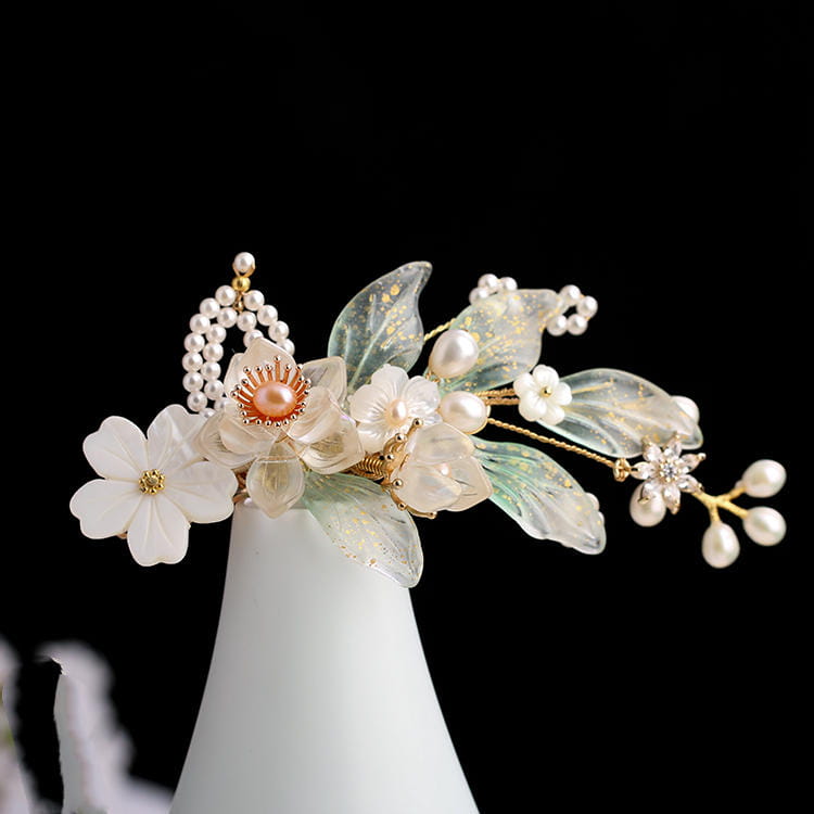 Elegant hanfu ancient style handmade fringed floral hair crown featuring translucent green and white petals, delicate pearls, a central peach-colored pearl, and gold-toned metalwork.