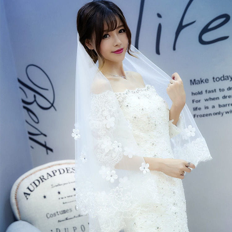 white lace wedding veil with delicate floral appliqués and sheer fabric showcasing the style veil korean and veil korean lace design of the korean lace petal bridal veil with floral embroidery