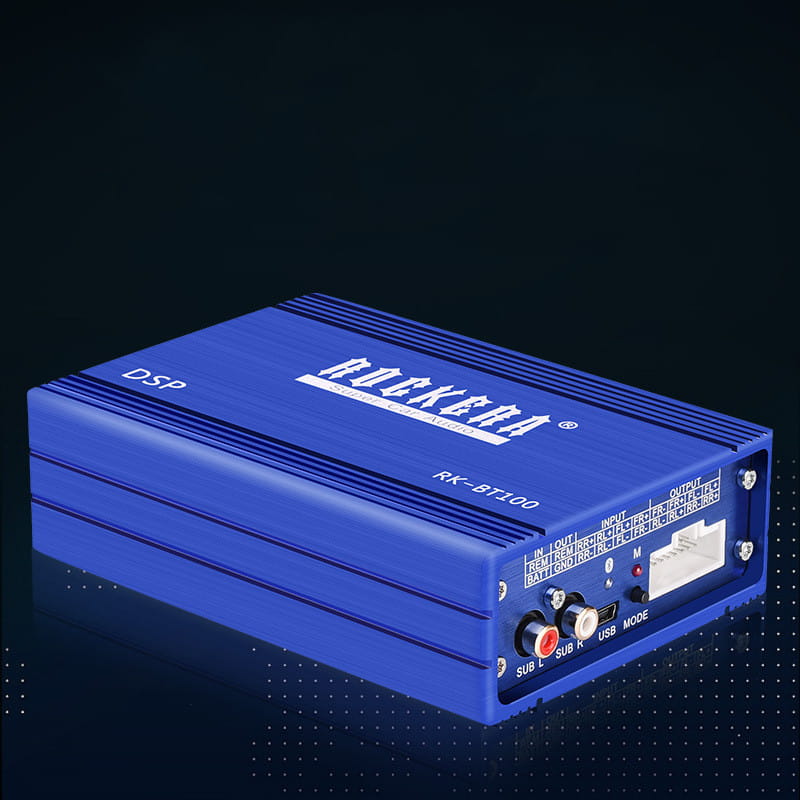 Blue Rockera RK-BT100 DSP audio processor with silver trim and labeled ports on the back side of a 4 channel car audio amplifier for enhanced car audio performance.