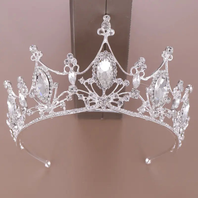 A sparkling silver crystal crown bride adorned with clear faceted crystals and ornate metalwork, designed as a bride golden headband.