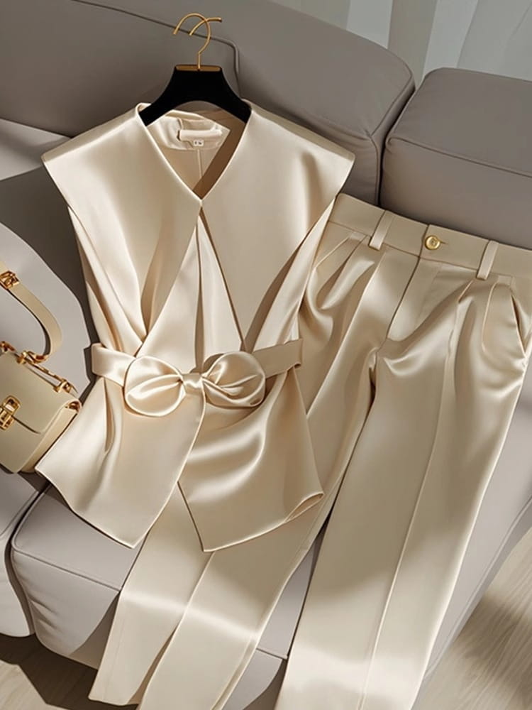 Cream satin sleeveless top with a wide collar and matching bow belt in youthful fashionable champagne style western style youthful fashion.