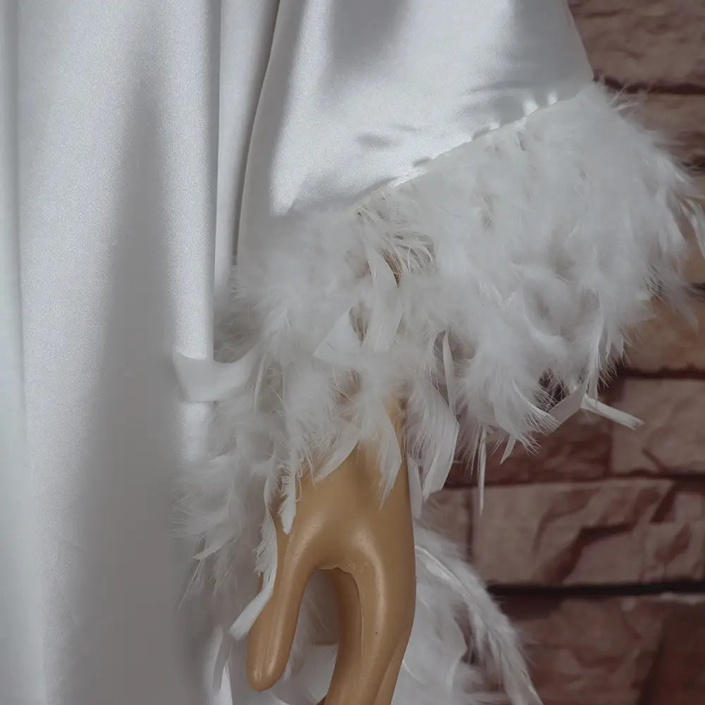 white satin loose dress luxury robe fully surrounded by fluffy white feather trim at the cuff