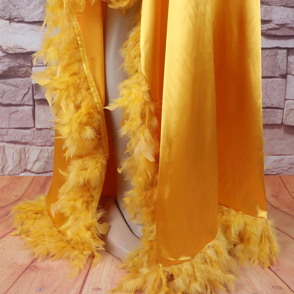 a vibrant yellow feather boa with satin ribbon edge and soft fluffy feathers complements the orange feathered loose dress luxury robe featuring a glossy fabric finish